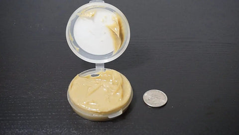 Open container of Universal Reel And Star Drag Grease For Fishing Reels Multi Use Lubricant 1 Pound Tub Tan Finish with quarter for scale