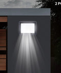 LED Work Light 100W 8000LM Flood Light Outdoor IP66 Weatherproof Plug in mounted on a wall, illuminating with broad beam.