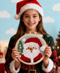 Child holding Santa Claus embroidery from Beginner Punch Needle Kit Santa Claus With Hoop Craft Embroidery Set Easy For Adults And Kids