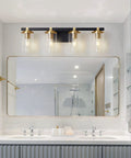 4 Light Modern Vanity Light Fixtures For Bathroom In Matte Black And Brushed Gold With Clear Glass Shades Over Mirror