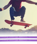 Skateboarder in mid-air with Rib Bones Rails For Skateboards Stable Flexible Longboard Rails With Screws, purple finish