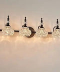Four Light Vanity Light Fixture In Black Painted Finish With Thick Crystal Glass Shade, side view on wall