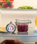 2-Pack Fridge Thermometer With Large Dial And Red Indicator in refrigerator beside cheese and jar, ideal for kitchen use.