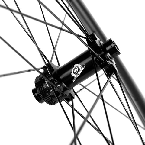 Close-up of Dope Carbon Fiber Road Bike Disc Brake Wheelset 700c hub and spokes, tubeless ready 88mm x 25mm rim, Shimano compatible.