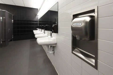 XLERATOR hand dryer in a bathroom with tiled walls, featuring the Boss Grade HEPA Filter Retrofit Kit for XLERATOR Hand Dryers.