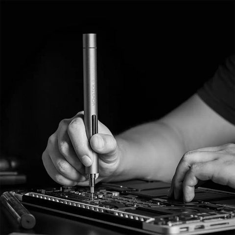 Lithium Precision Electric Screwdriver Kit With LED Light And Magnetic Mat, 56 Bit Set, Extend Bar in use on electronics device
