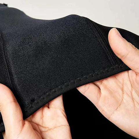 Hands holding flexible neoprene fabric of Lightweight Neoprene Wake Surf Vest For Men, showing stretchability and stitching.