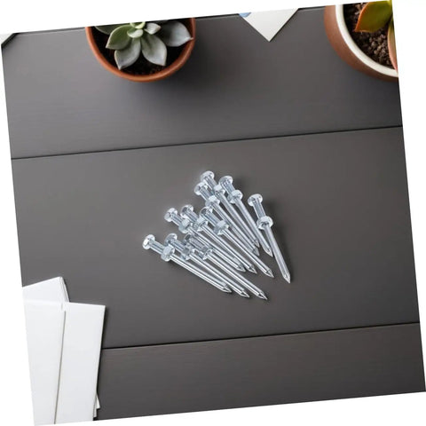 Heavy Duty Lawn Aerator Shoes With Replaceable Metal Spikes 12 Pack shown in a set of metal spikes on a table