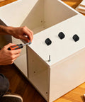 Person assembling furniture with U Shaped Chair Leg Caps Floor Glides For Bar Stools And Hardwood Floors Easy Clip On No Sweat