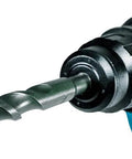 Close-up of Makita blue cordless hammer drill with SDS-Plus bit in chuck; carbide-tipped bit.