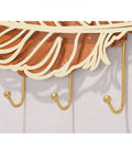 Rock Solid Wall Mount Coat Hooks With Sleek Modern Design Nail Down Easy Setup showcasing three gold hooks under a decorative leaf.