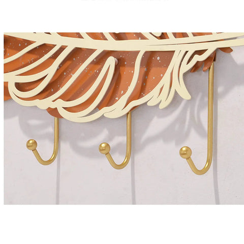 Rock Solid Wall Mount Coat Hooks With Sleek Modern Design Nail Down Easy Setup showcasing three gold hooks under a decorative leaf.