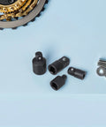 Heavy Duty 4-Piece Socket Adapter Set In 1/4 3/8 And 1/2 Inch Sizes Made From Gritty High Carbon Steel For Tough Jobs Easy Swap Between Tools No Hassle For Garage Pros Or DIY Guys Who Love Quality Gear. four black steel socket adapters on blue surface