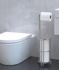 Toilet Paper Holder Stand And Tissue Roll Dispenser For Four Mega Rolls Freestanding Bathroom Storage Rack next to toilet.