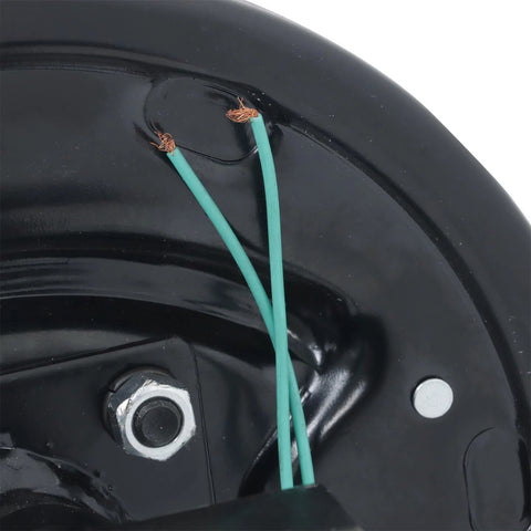 Close-up of black trailer axle end for an electric brake setup, showing green wires and a silver mounting bolt.