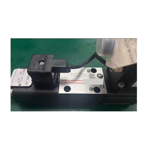 Electric proportional valve with silver metal nameplate and black solenoid coil housing, ATOS branding
