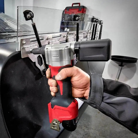 Beefy Cordless Rivet Tool For 12 Volt Power Batteries pulling steel fasteners with ease in a workshop setting.