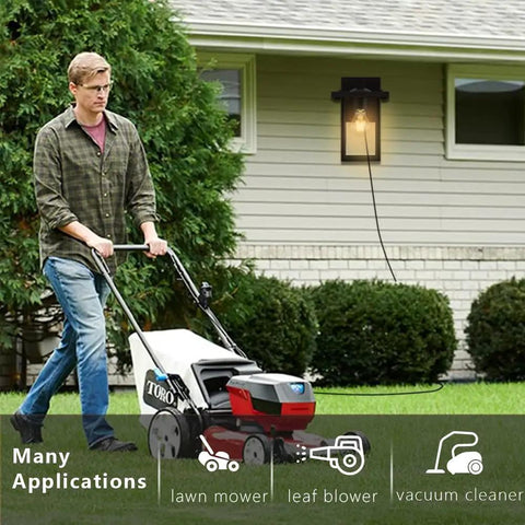 Man mowing lawn near black outdoor wall mount porch light with two built in GFCI outlets and weatherproof fixture for home