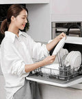 Pretty Slick Portable Automatic Countertop Dishwasher With Dual Overhead Spray Built In Water Tank And Air Dry Cycle in use with plates and utensils.