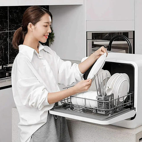 Pretty Slick Portable Automatic Countertop Dishwasher With Dual Overhead Spray Built In Water Tank And Air Dry Cycle in use with plates and utensils.