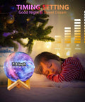 Sleeping child beside Moon Lamp For Kids Galaxy 16 Colors 3D Moon Light With Wood Stand Remote And Touch Control USB Rechargeable Night Light Gift For Girls Birthday Bedroom Decor, showing timing settings and 7.3 inch size.
