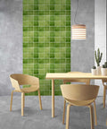 Green 3D Peel And Stick Tile Backsplash Squares 11.8x11.8 Inches Ultralight PVC on interior wall behind modern dining setup.