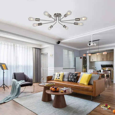 Mid Century 8 Light Chandelier in Brushed Nickel installed in a modern living room with sleek furniture and decor