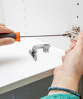 Person installing Stainless Steel Cabinet Hinges 4 Pack Concealed Mounting Hardware For Corner Doors With Soft Close Dampers.