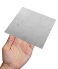 Two Piece Square Stainless Steel Sheet 100x100x2mm Flat Metal Plate Smooth Mill Finish For Industrial Fabrication Diy Projects Hardware Repair Built Tough Ready To Roll held in hand.