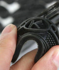 Close-up of a hand holding a black polyurethane heel pad, part of a 10 Pack Rubber Sole Heel Saver Pads For Shoes Taps Toe Plates DIY Glue On Repair Anti Slip Shoe Repair Pads For Women And Men Fits Any Shoe Durable Polyurethane Rubber Easy Install.