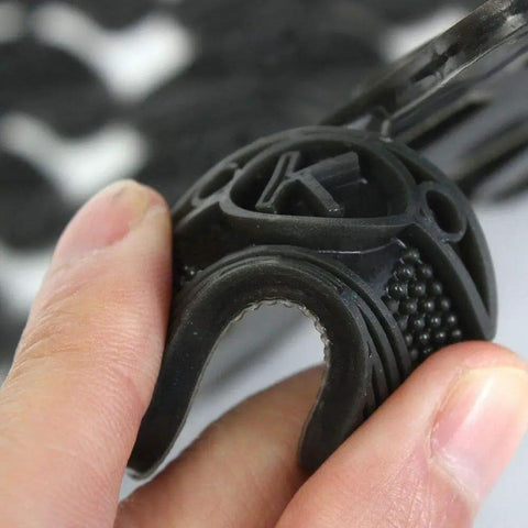 Close-up of a hand holding a black polyurethane heel pad, part of a 10 Pack Rubber Sole Heel Saver Pads For Shoes Taps Toe Plates DIY Glue On Repair Anti Slip Shoe Repair Pads For Women And Men Fits Any Shoe Durable Polyurethane Rubber Easy Install.
