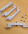 False Front Connector And Cabinet Clips Set For Four And A Half Inch Opening Drawers with screws on orange background