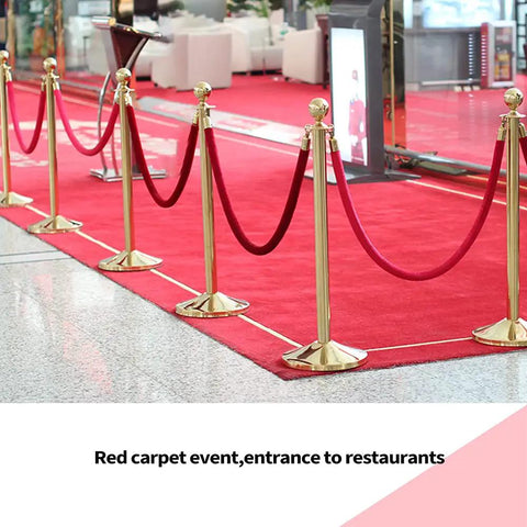 Two Piece Red Velvet Stanchion Rope Set With Polished Gold Hooks for VIP Crowds at red carpet entrance in upscale venue.