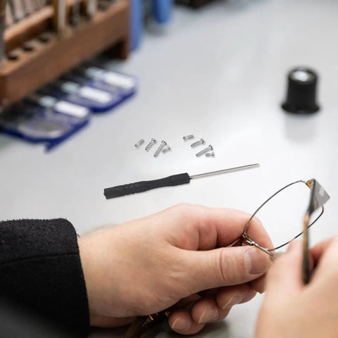 Person using Eyeglass Repair Kit With 527 Replacement Screws And Nose Pads Gotta Have Precision Screwdriver Set for repairs
