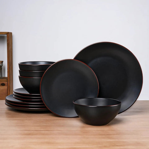Venus 12 Piece Stoneware Plates And Bowls Set With Trim Chip Resistant Dinnerware For Four Matte Black displayed on wooden table