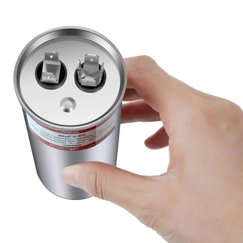 Hand holding 30uF CBB65 AC Capacitor For HVAC Air Conditioners Pool Pumps Condenser Fans And Motor Start Capacitor Replacement 370V 440V 450V 50 60Hz Five Percent Tolerance showing terminals