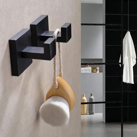 Matte Black Stainless Steel Wall Hooks Two Pack Heavy Duty Coat and Towel Hangers for Bathroom and Kitchen Square Modern Mount Rustproof and Durable Perfect for Coats Towels Bags Hats holding a bath brush