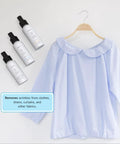 3-In-1 No Iron Wrinkle Release, Static Cling Remover, Odor Eliminator And Fabric Refresher Spray next to a blue blouse on hanger