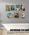 Bathroom wall with humorous animal signs next to bathtub.