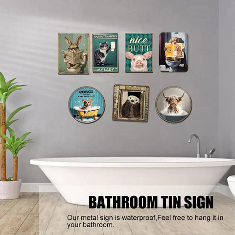 Bathroom wall with humorous animal signs next to bathtub.