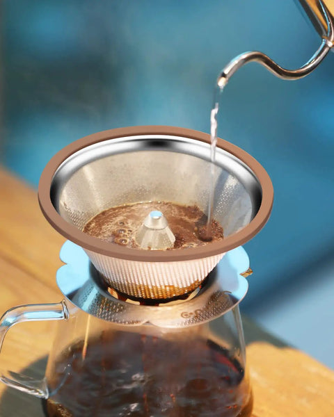 Pouring hot water into a Stainless Steel Pour Over Coffee Dripper Cone 1 To 3 Cup, Reusable Paperless Metal Filter on a glass carafe.
