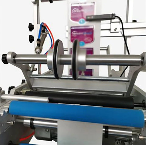 Close-up of Semi Automatic Round Bottle Labeling Machine with dual side rollers and easy access foot switch for production.