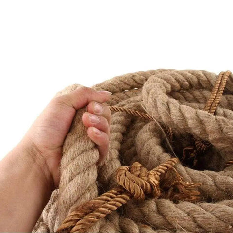 Hand holding 100 Percent Natural Hemp Rope Thick 1 Inch By 100 Ft for heavy duty outdoor use, showing braided texture and strength.