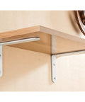 Solid As A Rock Heavy Duty Wall Mounted Shelf Brackets For Clean Floating Planks With Gritty Industrial Look And No Sweat Setup For Impressive Home Organization Hacks Set Of Two Bright White installed under a wooden shelf.