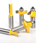 Close-up of four carbide-tipped bits from the Professional Router Bit Set With Thirty Five Pieces And One Half Inch Shank