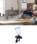 Super Slick Hvlp Air Paint Sprayer With 1.7Mm Nozzle And Six Hundred Ml Reusable Cup held by user spraying on wood surface.