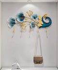 Sleek Wall Mounted Coat Rack With Extended Hook Arms For Entryway, modern design with decorative leaves and bag hanging.