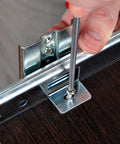 Installing Top Notch Keyboard Slide Out Tray Rails With Drawer Track Guides 27Mm White on a desk with a screwdriver.