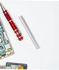 Close-up of red screwdriver, electronic device parts, and aluminum repair tube from 8 Piece Aluminum Tent Pole Repair Tubes Set Sturdy Replacement Accessories For Camping Hiking And Backpacking Universal Fit Tent Fittings And Connector Rods For Quick Repairs Portable Lightweight Outdoor Gear.
