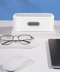 15W Ultrasonic Cleaner Machine With 400Ml Tank, Perfect For Jewelry, Glasses, Watches, And Manicure Tools on a desk with glasses.